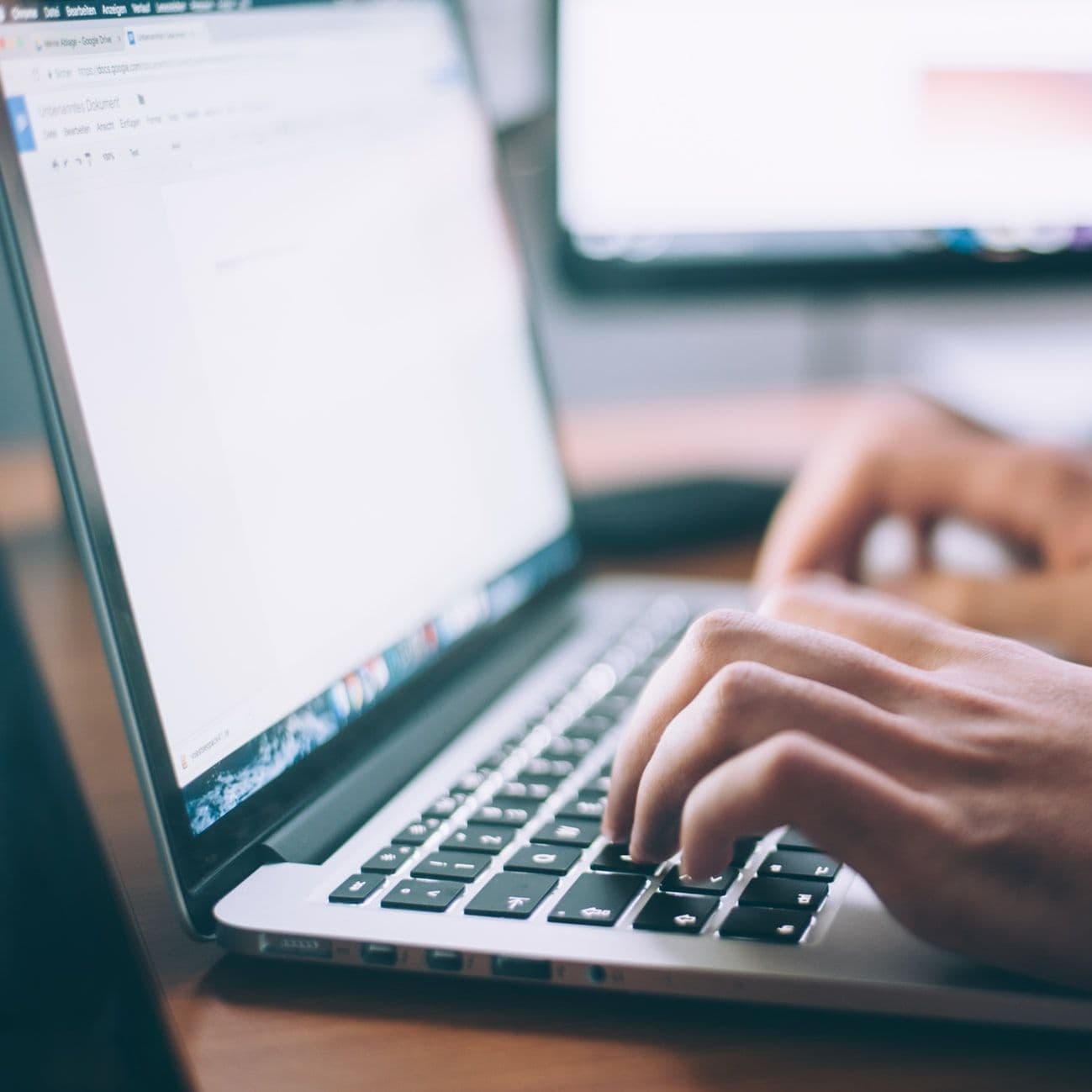 blogger is typing a blog post on his laptop